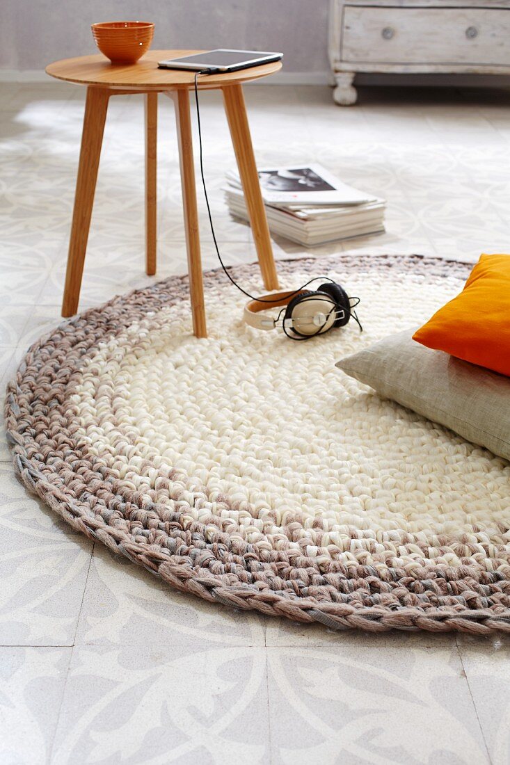 A homemade, round crocheted rug in brown tones