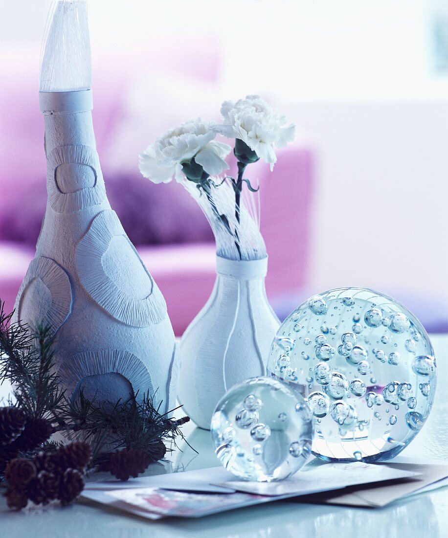 Winter arrangement of vases and glass baubles