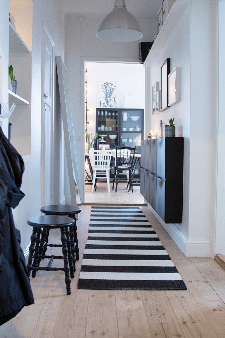Black and white furniture in hallway and dining room