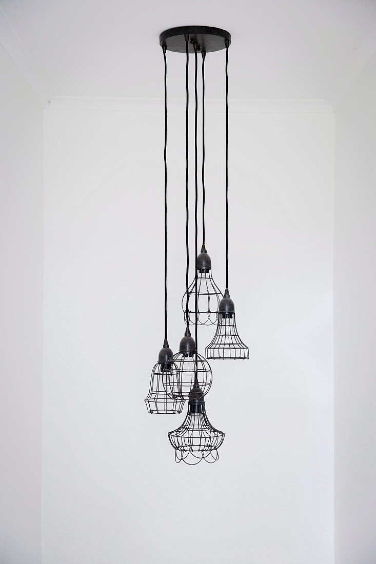 Pendant lamp group with dark wire shades in different shapes