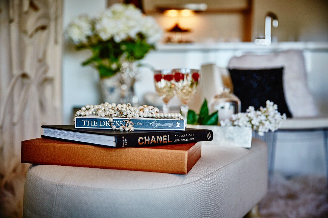 Bead necklace on top of books stacked on footstool