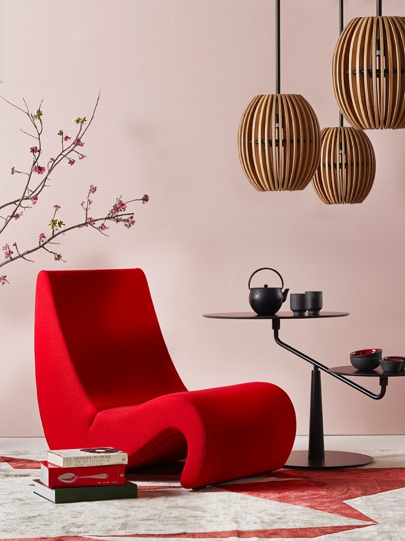 Romantischer Japanstil: Organisch geformter Sessel neben schwarzem Beistelltisch