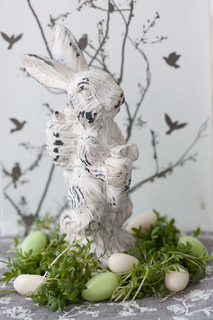 Easter bunny in nest of cress and sugar eggs