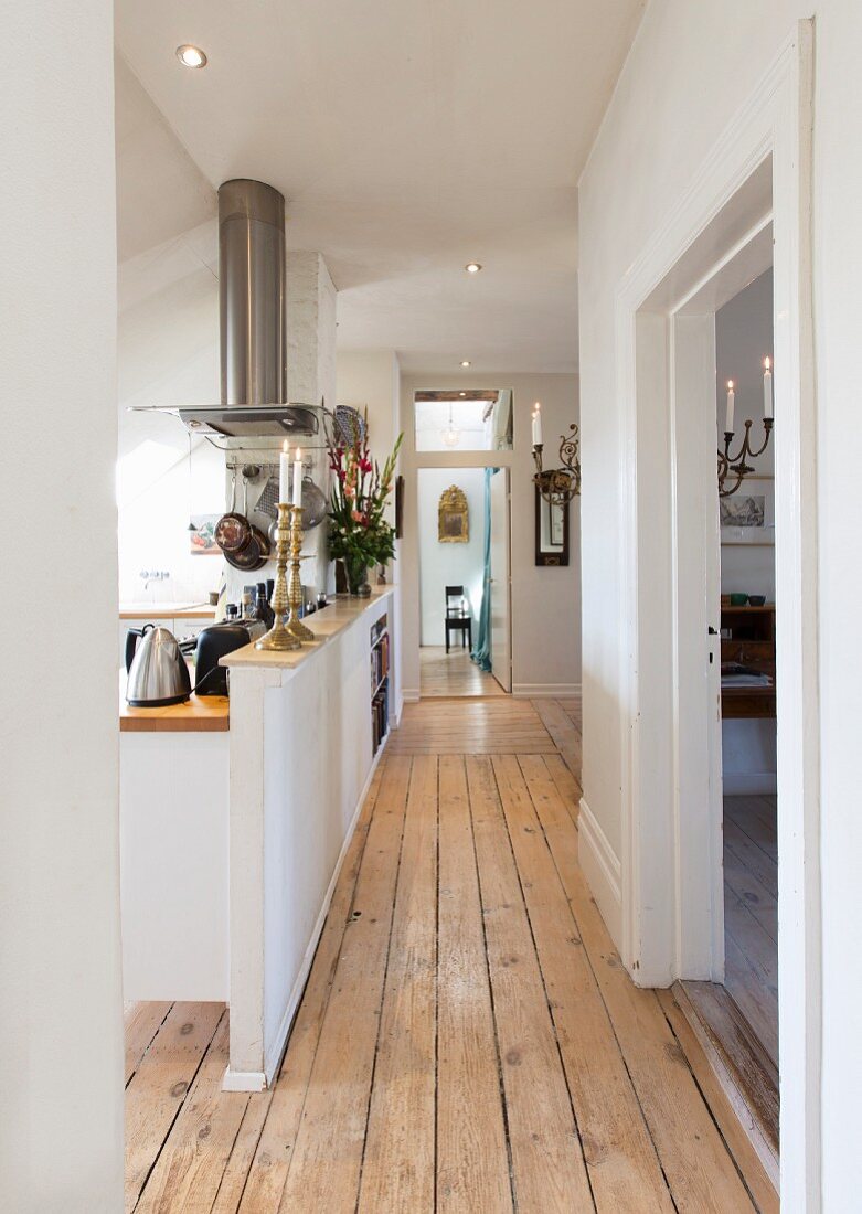 Board floor in corridor and open-plan kitchen behind half-height partition wall