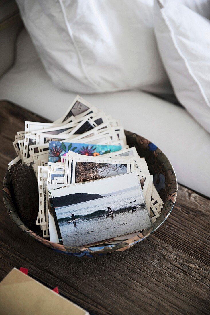 Postcards and photos in a bowl