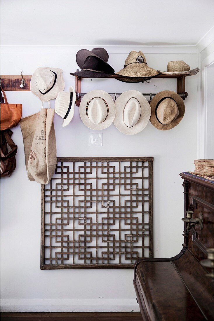 Wardrobe with hat collection over a graphic grid