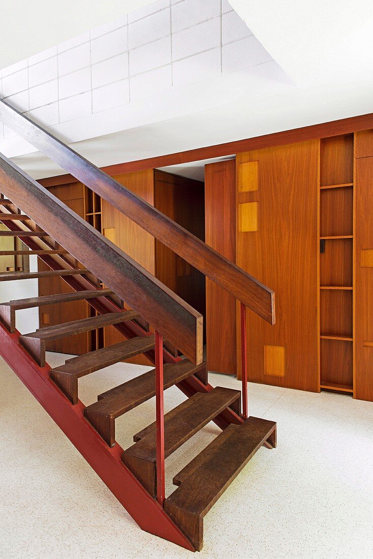 Custom built-in wardrobe with shelf and sliding door next to the staircase