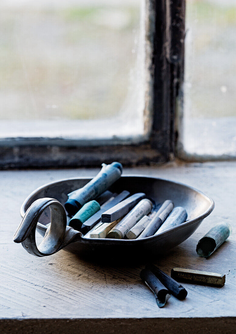 Artists' chalks in small pewter dish with handle