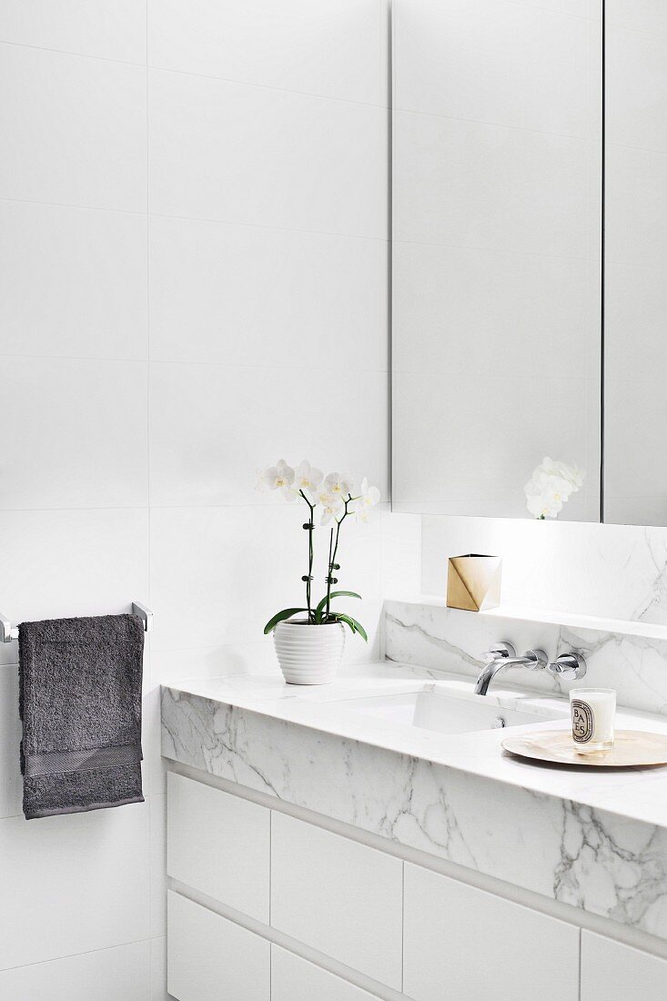 White bathroom with marble vanity top