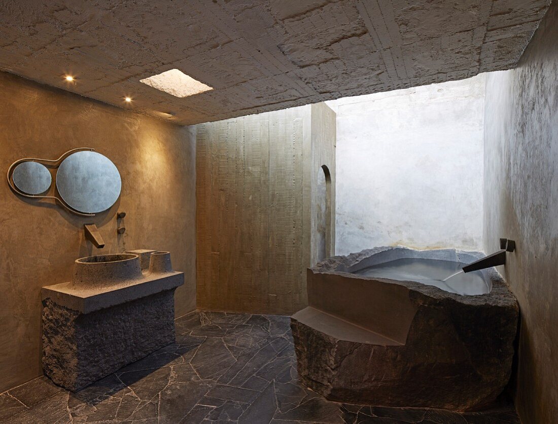 Béton brut in bathroom; bathtub and sink made from moulded concrete