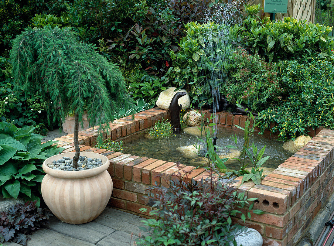 Bricked pond with fountain and copper beaver
