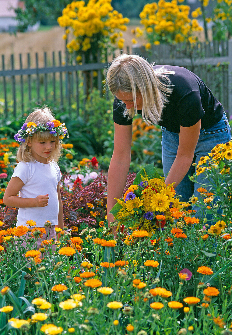 Mother and daughter picking flowers