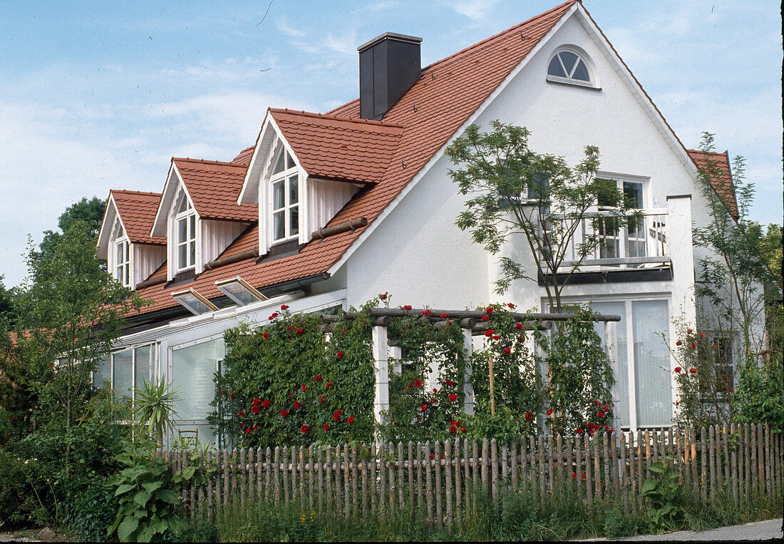 Pergola with residential building and conservatory