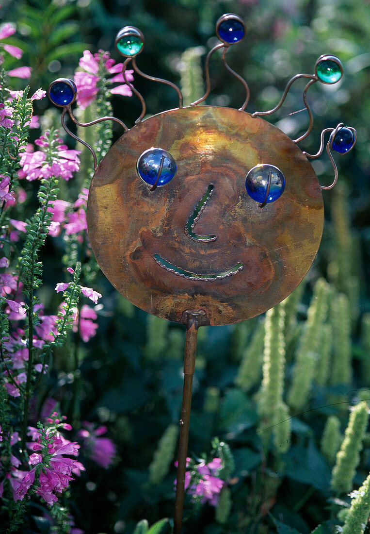 Funny face made of copper and glass balls