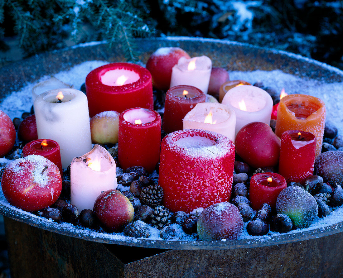 Metal tray with candles in hoarfrost