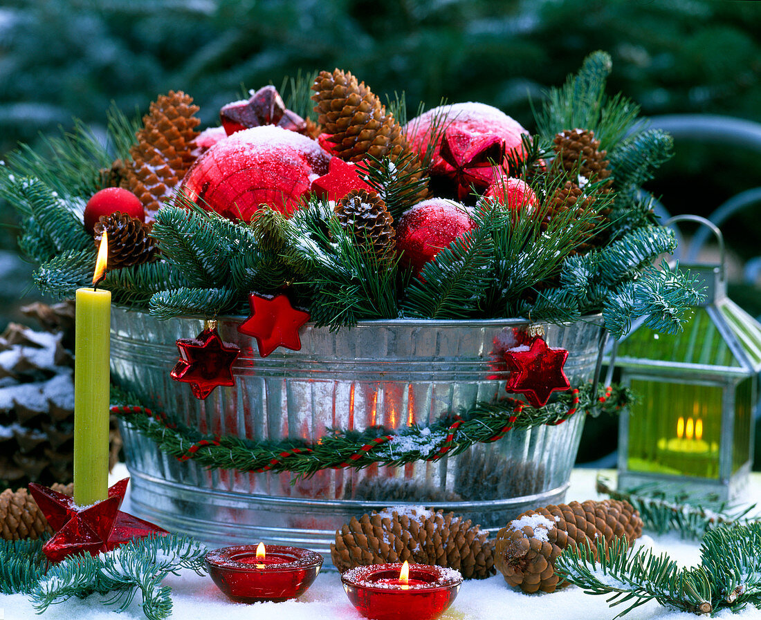 Metal bowl with branches and Christmas decorations