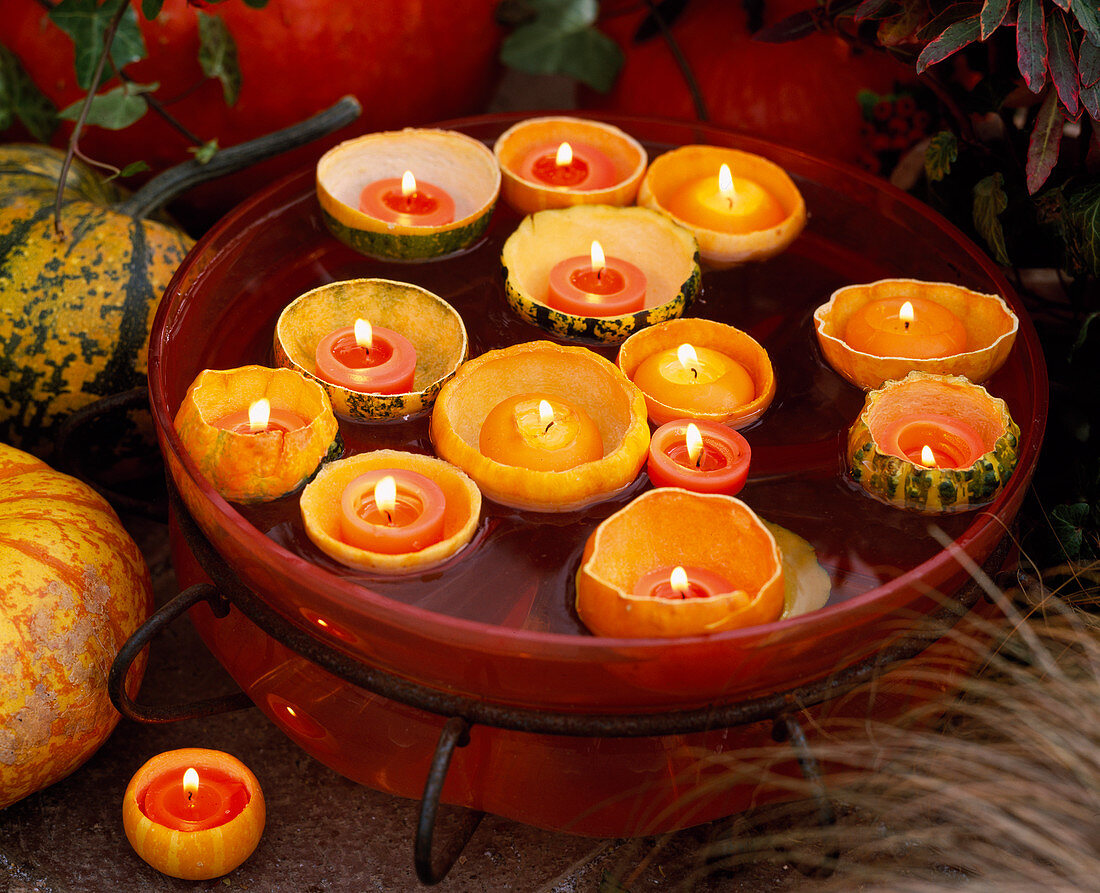 Cucurbita eroded (pumpkin), with candles floating in glass bowl