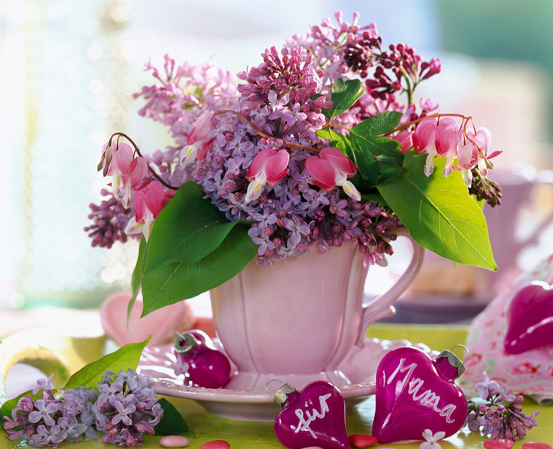 Pink cup with syringa (lilac)
