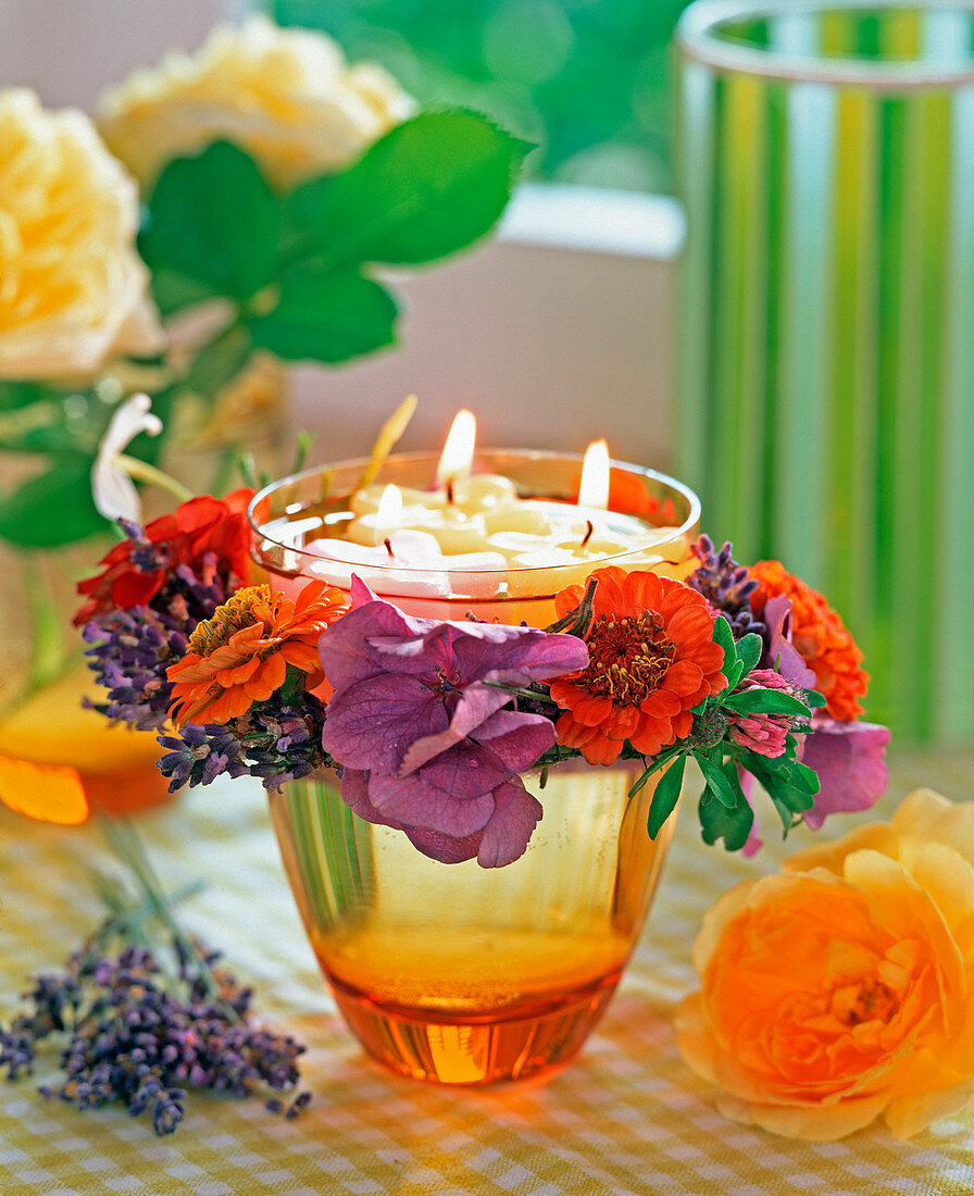 Glass with floating candles and Zinnia