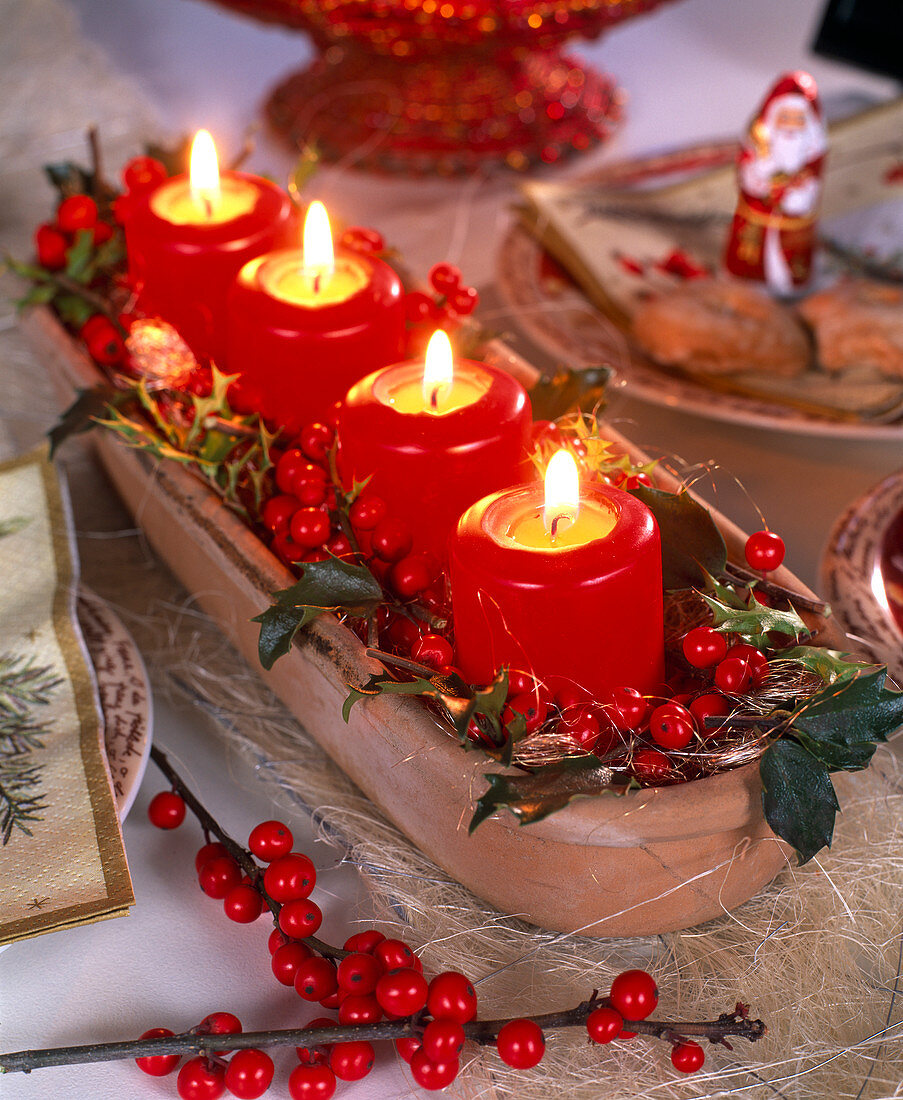 Unusual Advent wreath with red candles and ilex