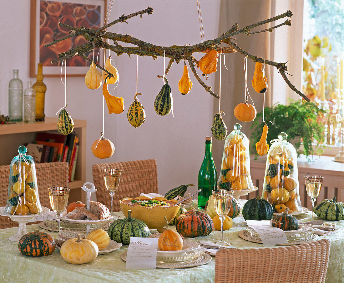 Table decoration with cucurbita, pumpkins under glass bells, as place cards