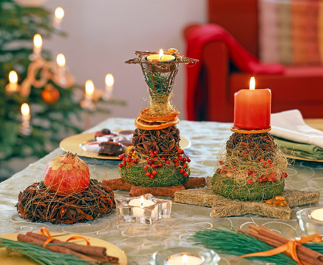 Table decoration with star anise balls, wreaths and candles