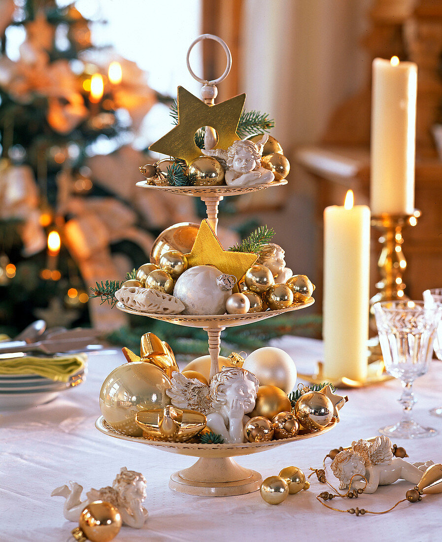 Beige metal etagere with golden and cream tree decorations