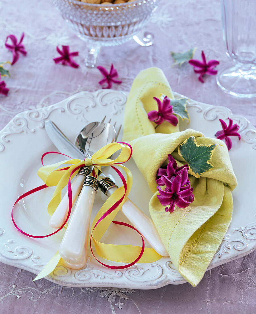 Knotted yellow napkin with flowers of Hyacinthus (hyacinth)