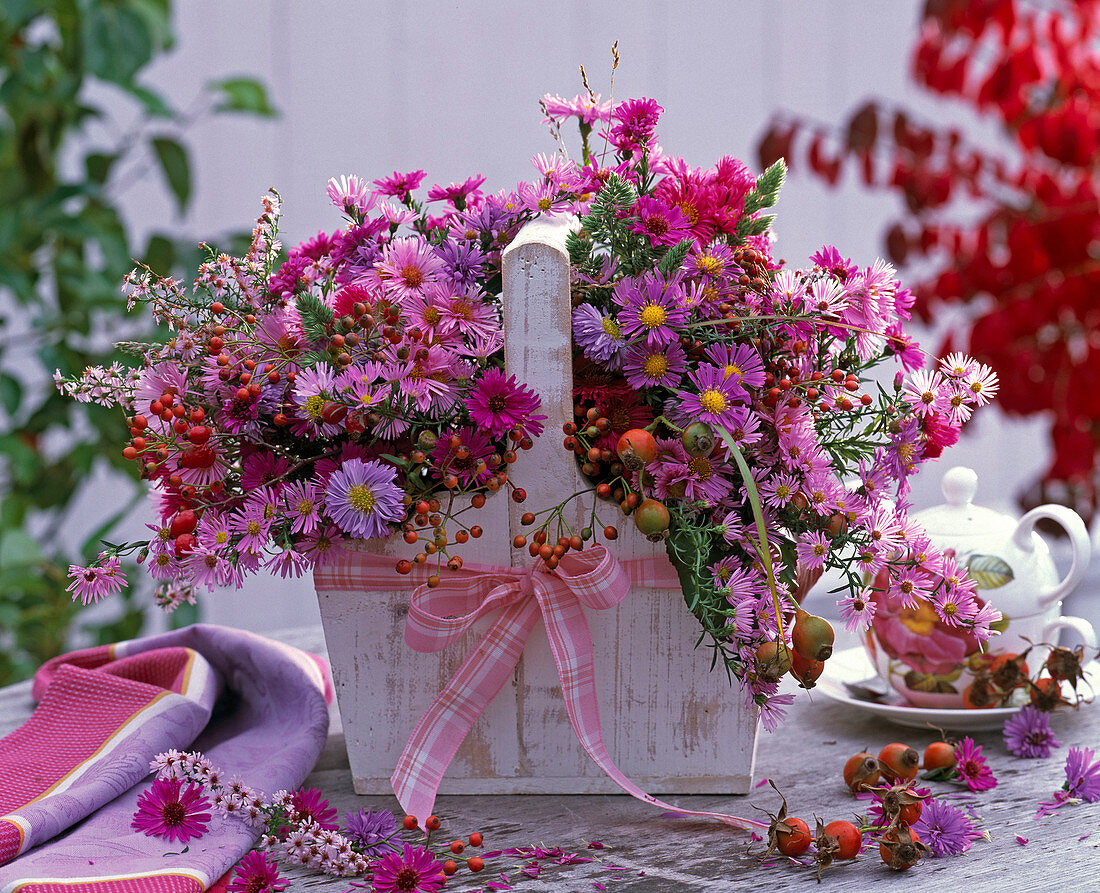 Asters bouquet in the wooden basket