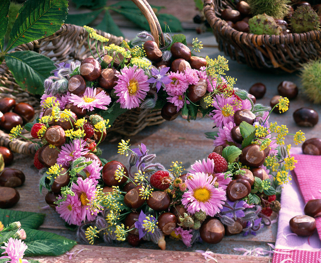 Autumn wreath with asters, chestnuts and fruits