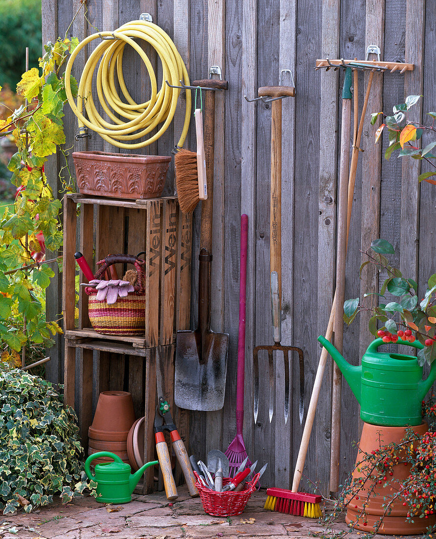 Still life with gardening equipment garden hose, broom, spade, grave fork