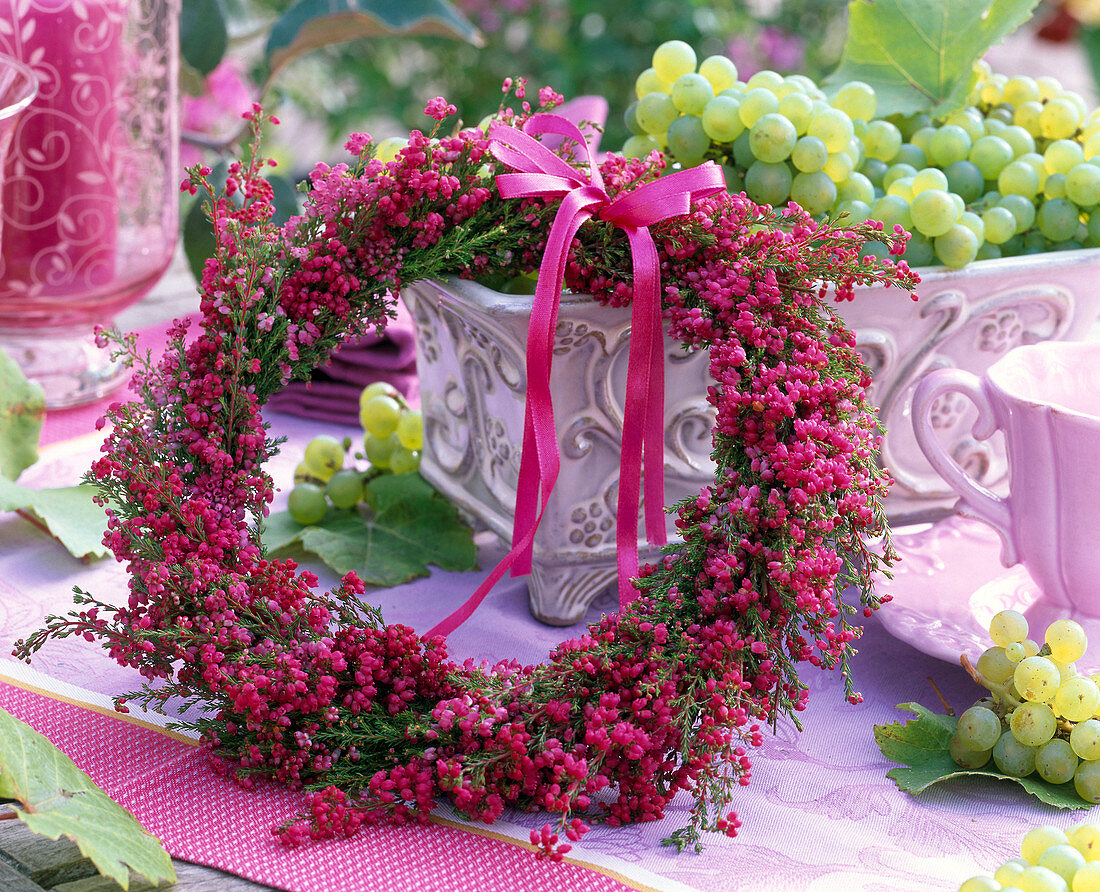 Erica wreath leaning on tray, Vitis on the table