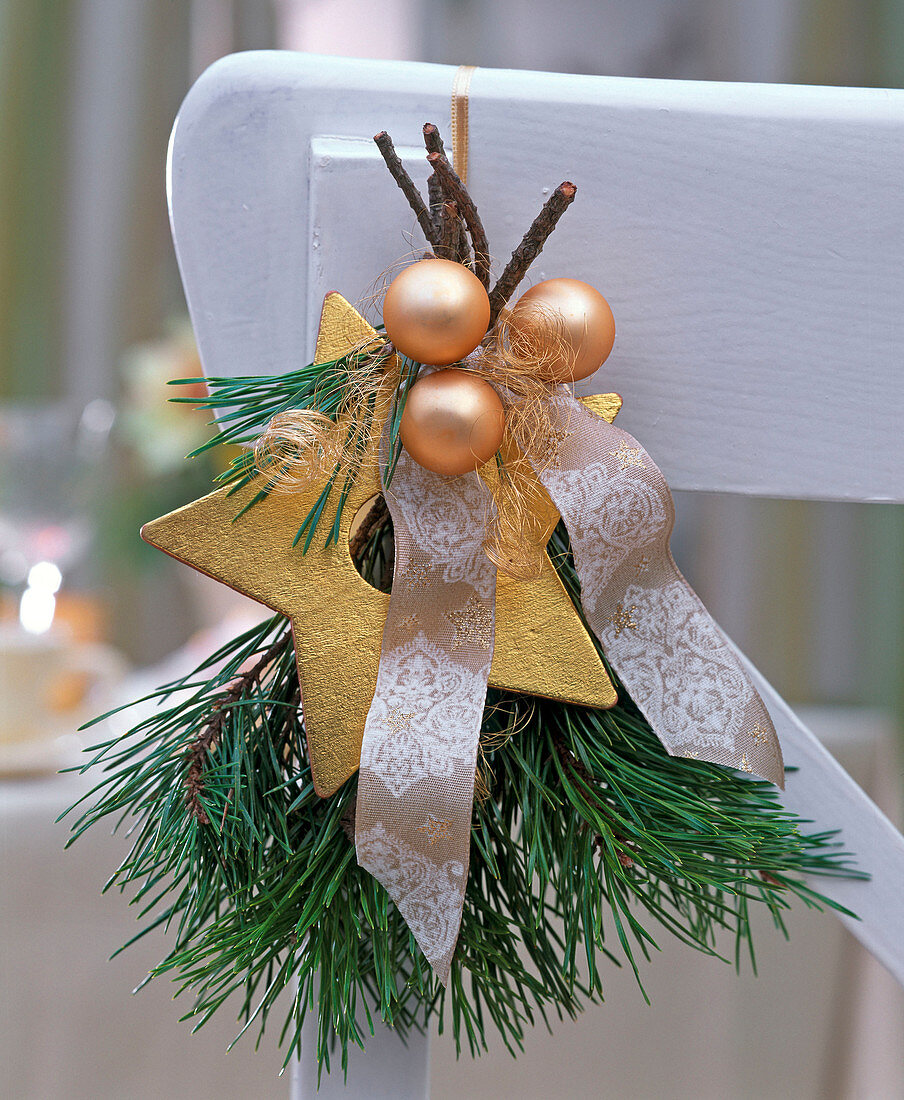 Small bouquet made of pinus, golden Christmas tree balls, star