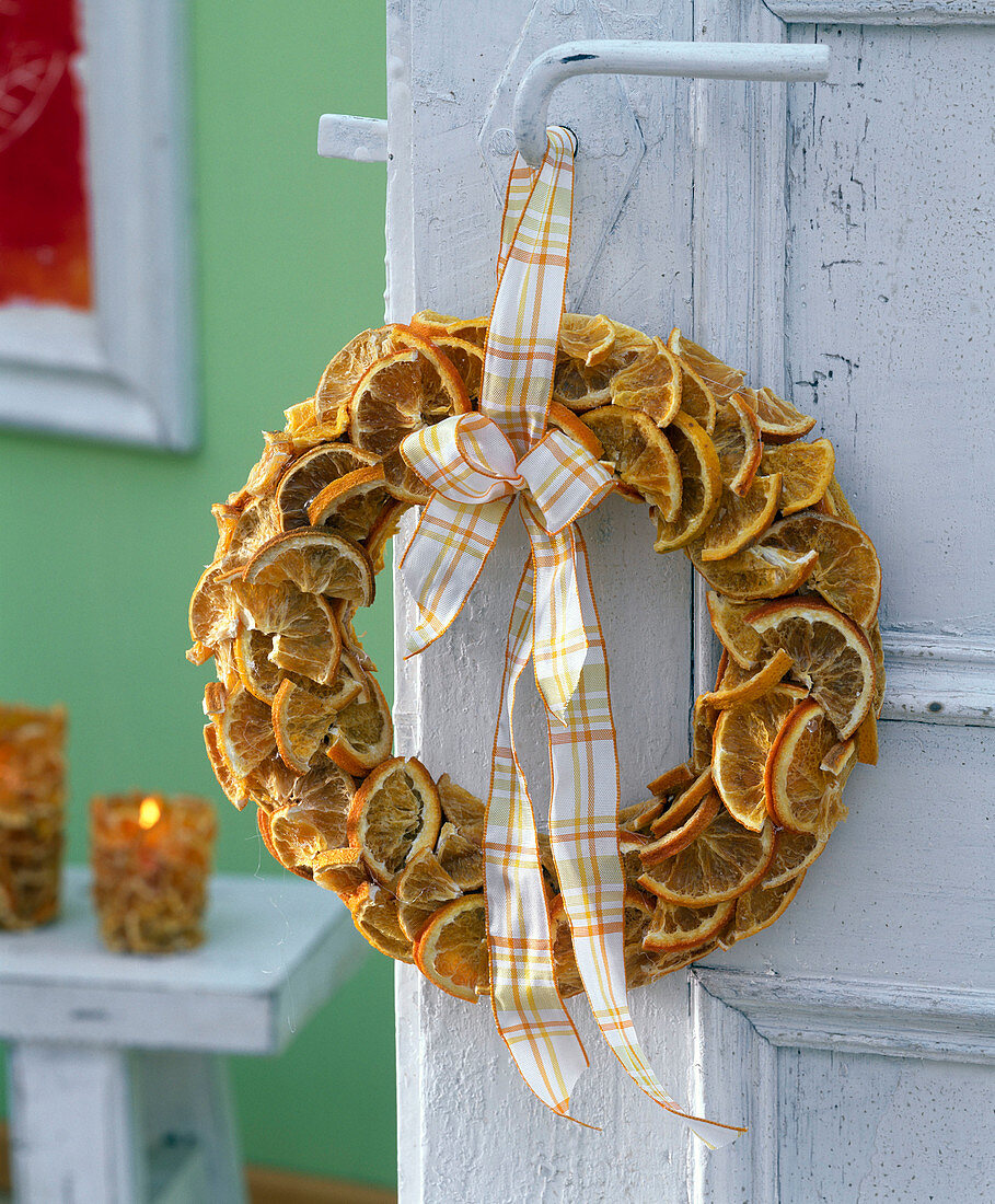 Cover straw wreath with glued on orange pieces