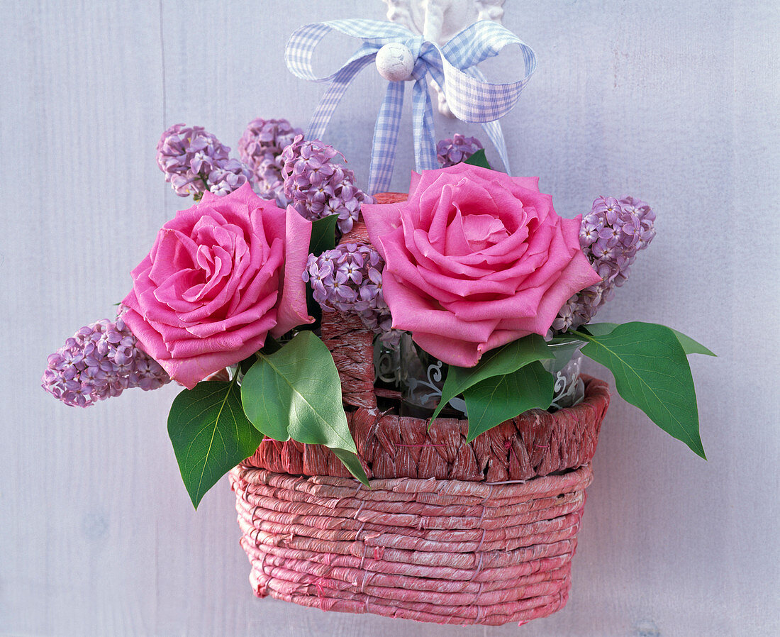 Rose, syringa in a small woven handle basket