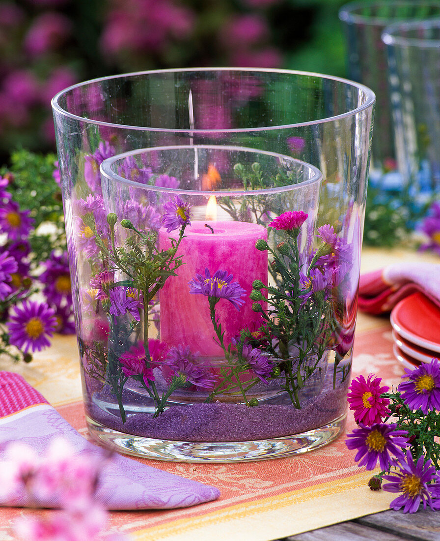 Lantern filled with aster and purple decorative sand