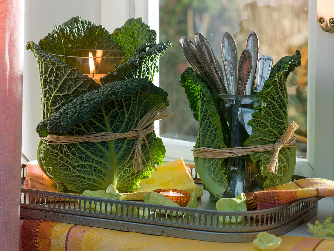 Lantern and cutlery glass wrapped with Brassica leaves