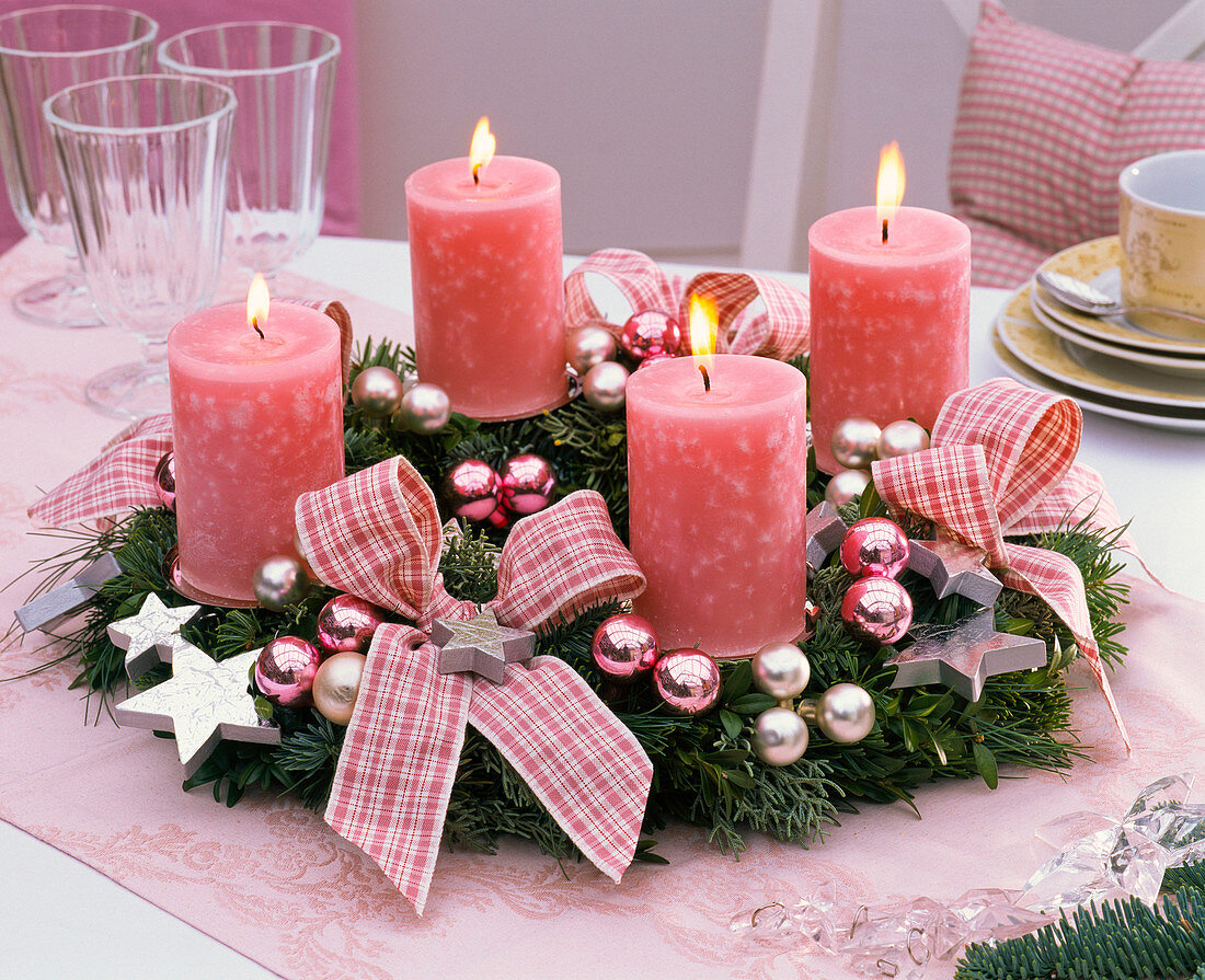 Advent wreath of mixed green, pink candles, bows, Christmas tree balls