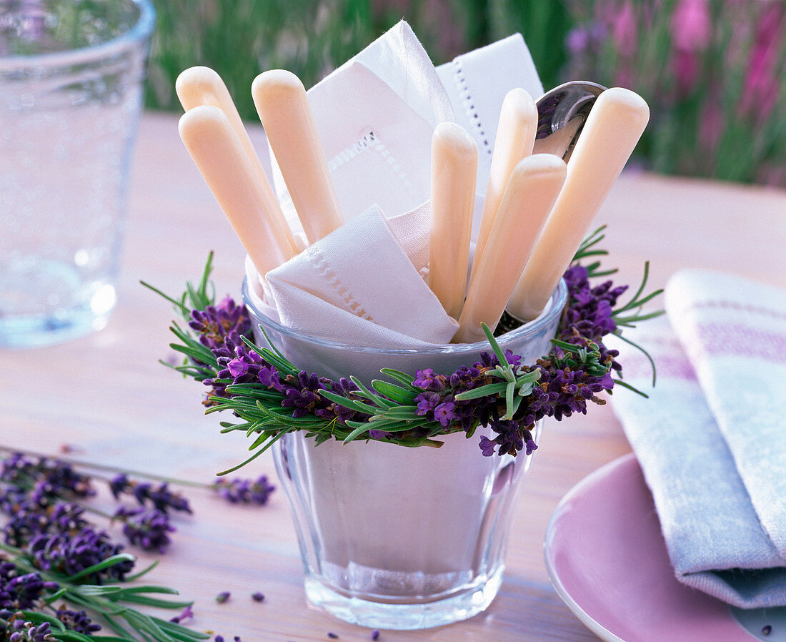 Wreath of lavandula (lavender) around glass with napkin and cutlery