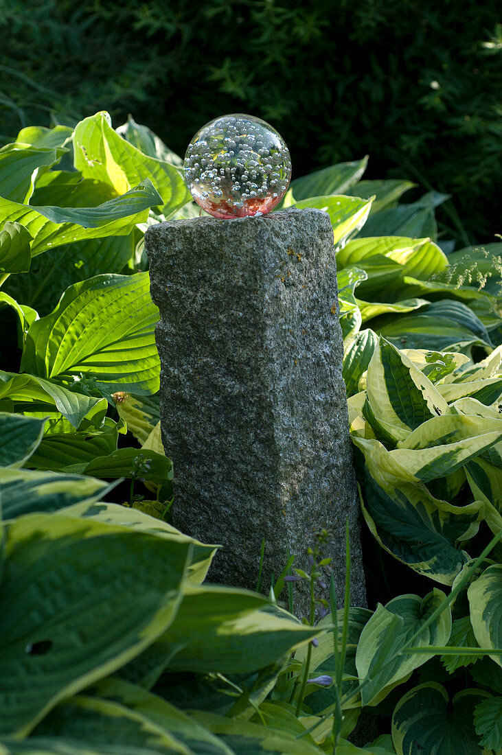 Glass ball on granite cube