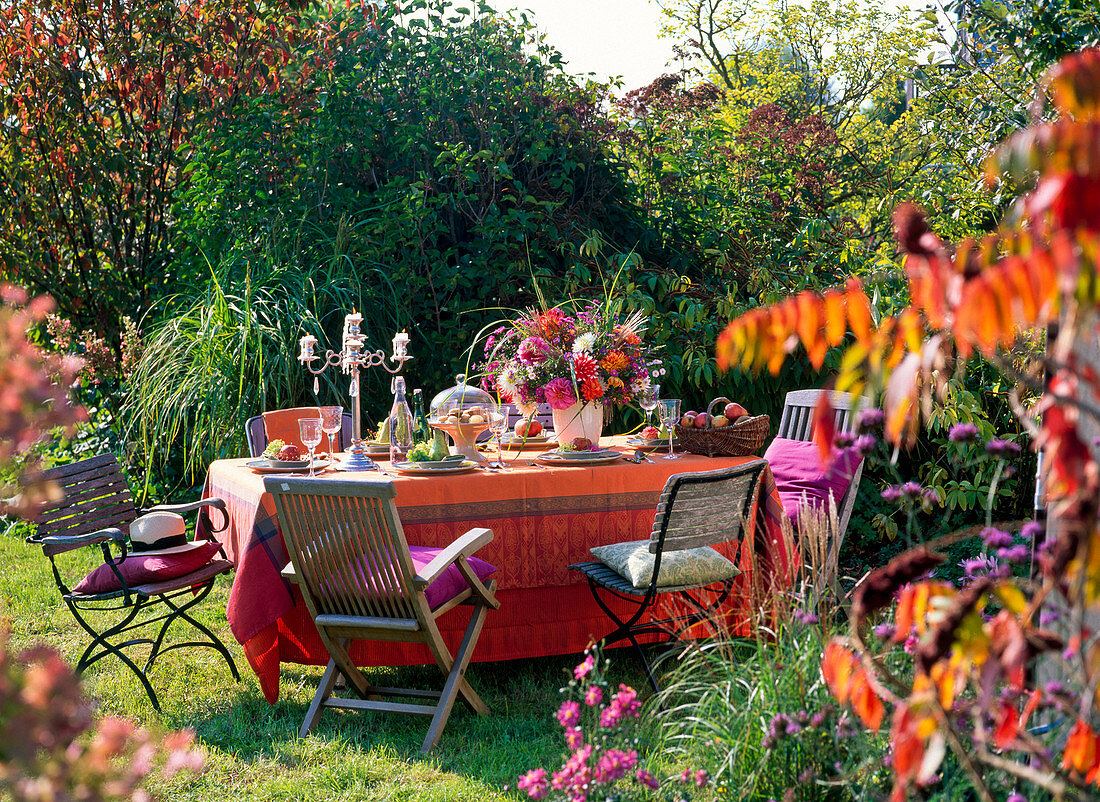 Laid table in the garden with late summer bouquet