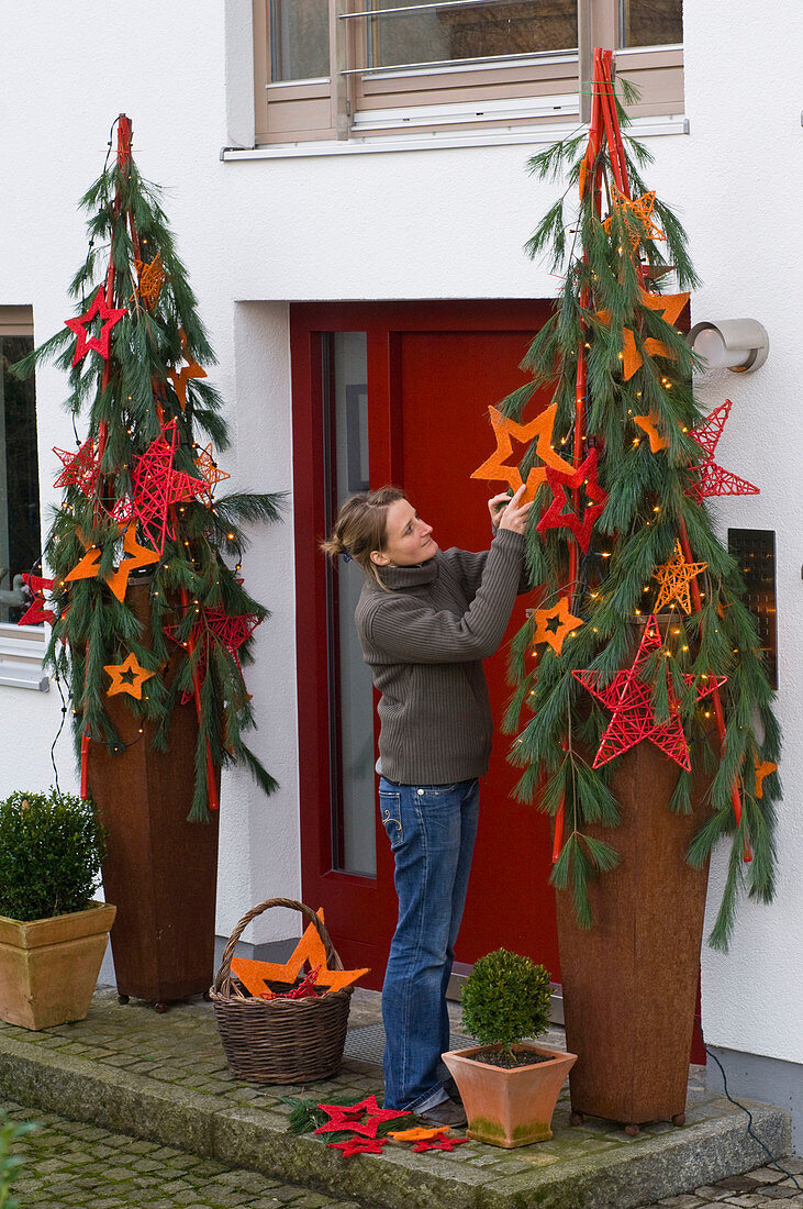 Red front door decorated for Christmas