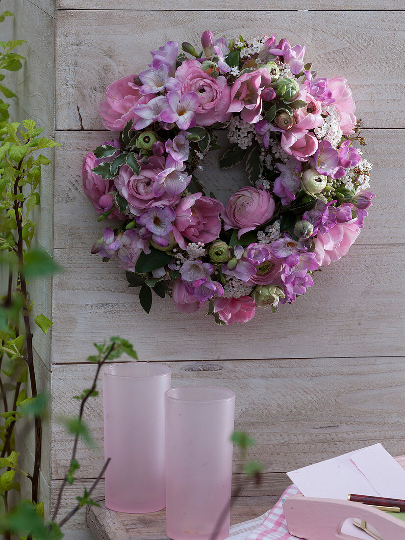 Pink-white scented wreath on wooden wall