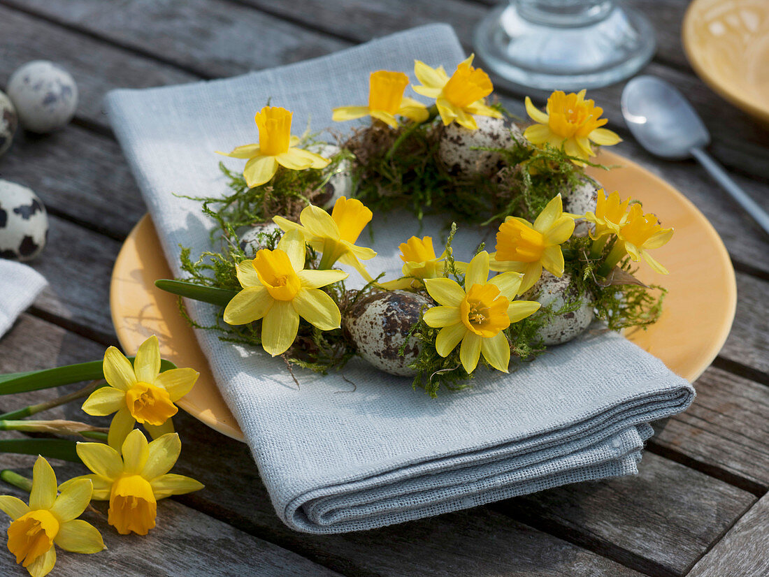 Small wreath of narcissus with moss and quail eggs