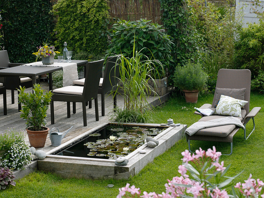 Build mini-pond out of flower bed with wooden border