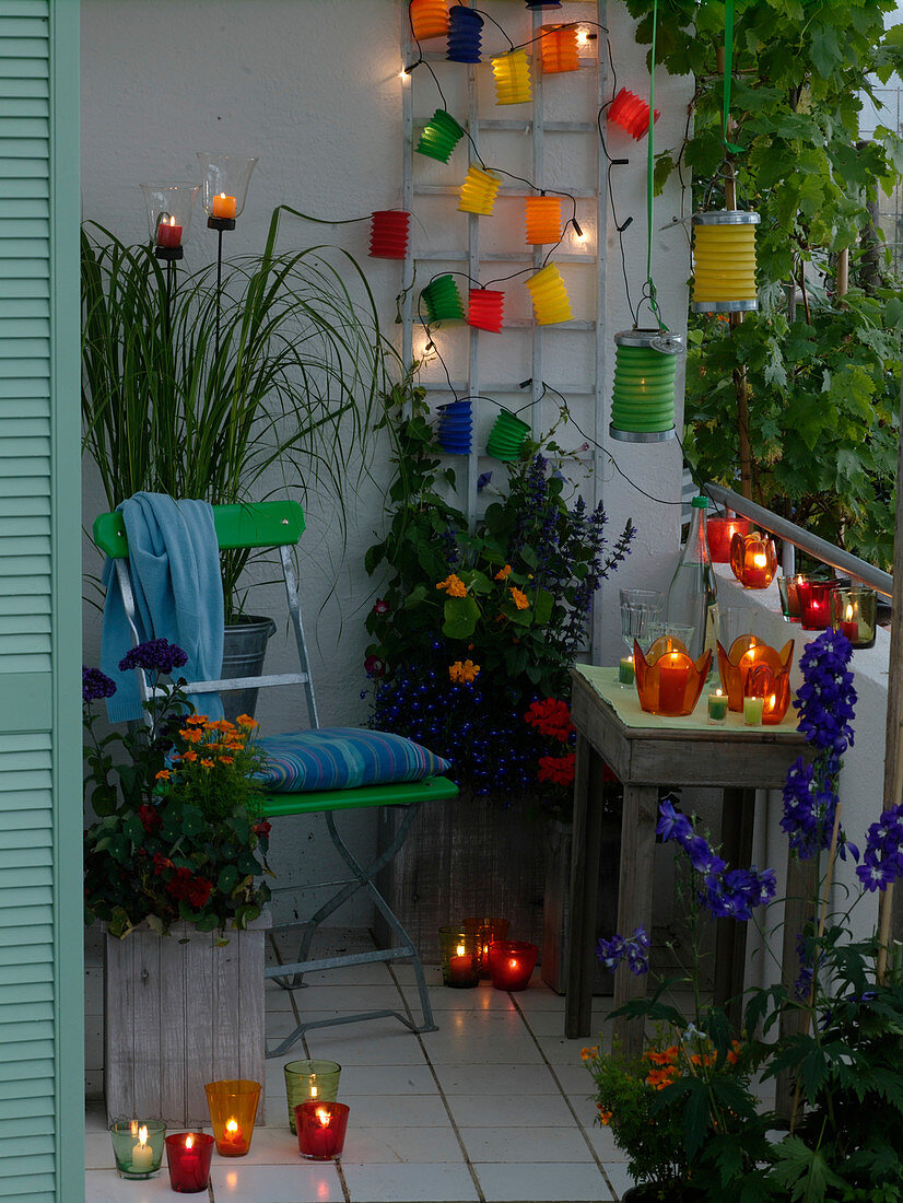 Colorful summer balcony with lanterns, fairy lights and lanterns
