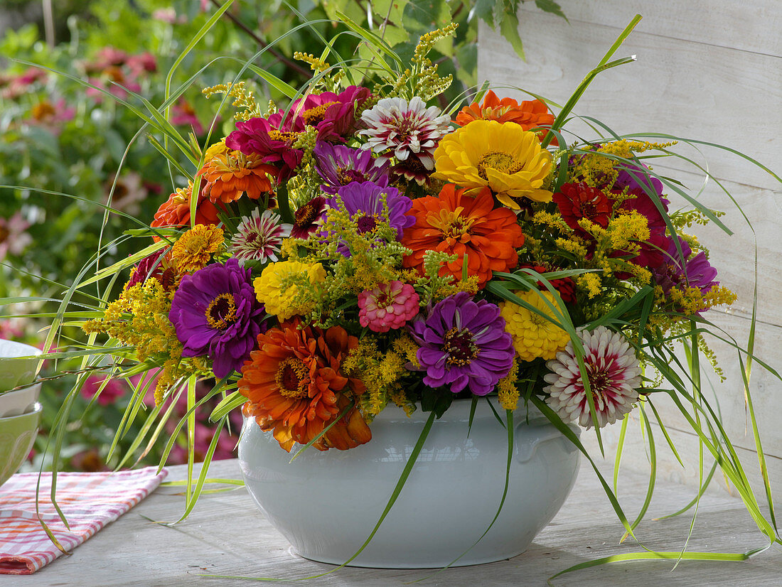 Colorful late summer arrangement in white cup