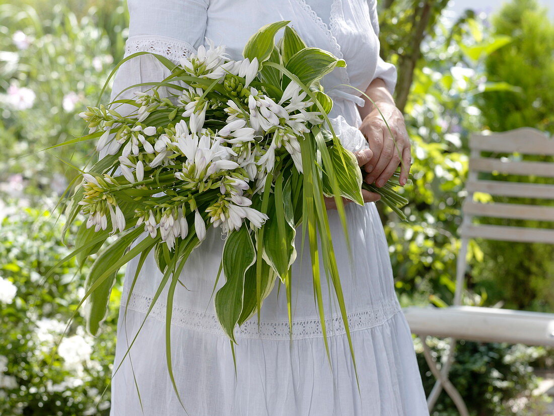 Fragrant wedding bouquet of lilies Funkie with grass bow