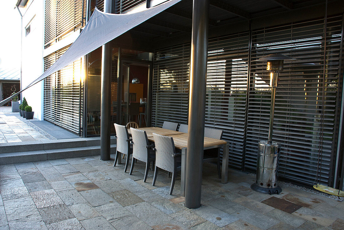 Shaded terrace with awning, seating group, heating mushroom