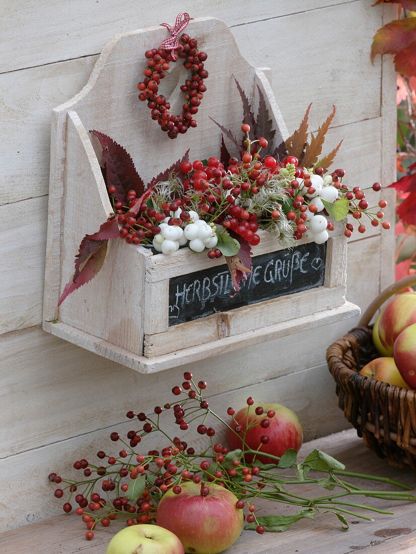 Small, white wooden shelf, filled with autumn berries